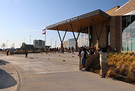  A large group of people stand out front of a school